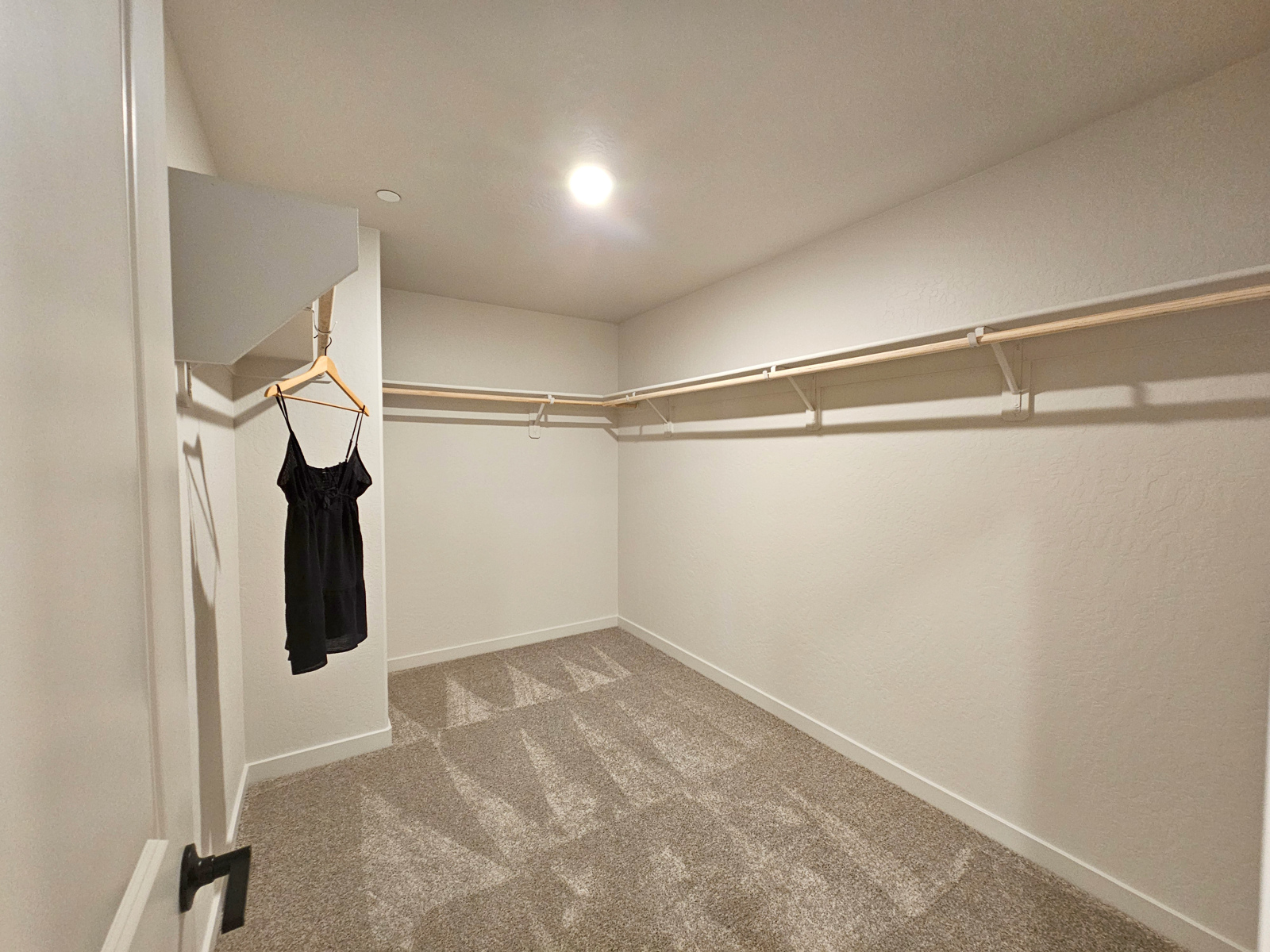 A hallway with a coat rack.