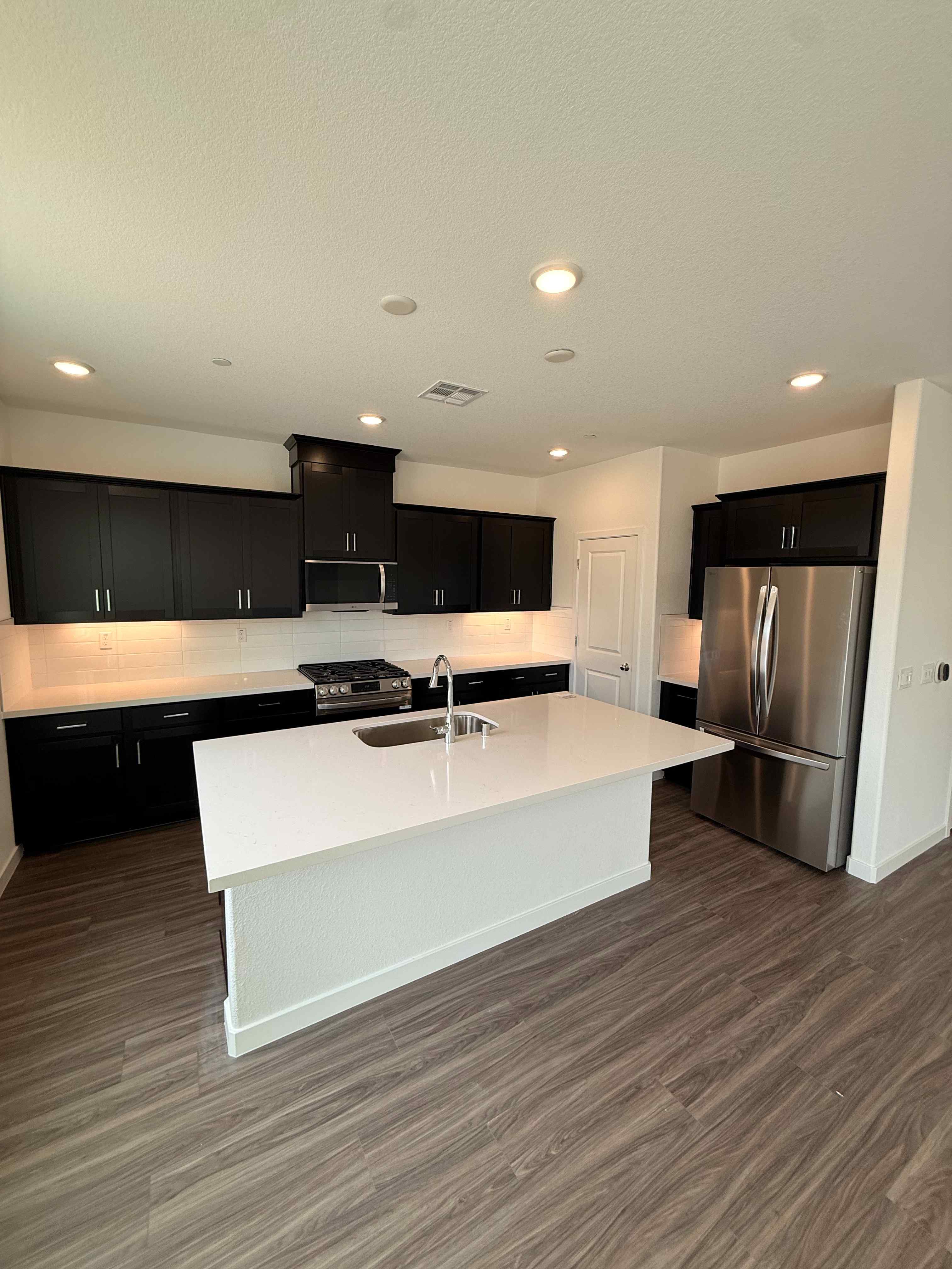 A kitchen with black cabinets.