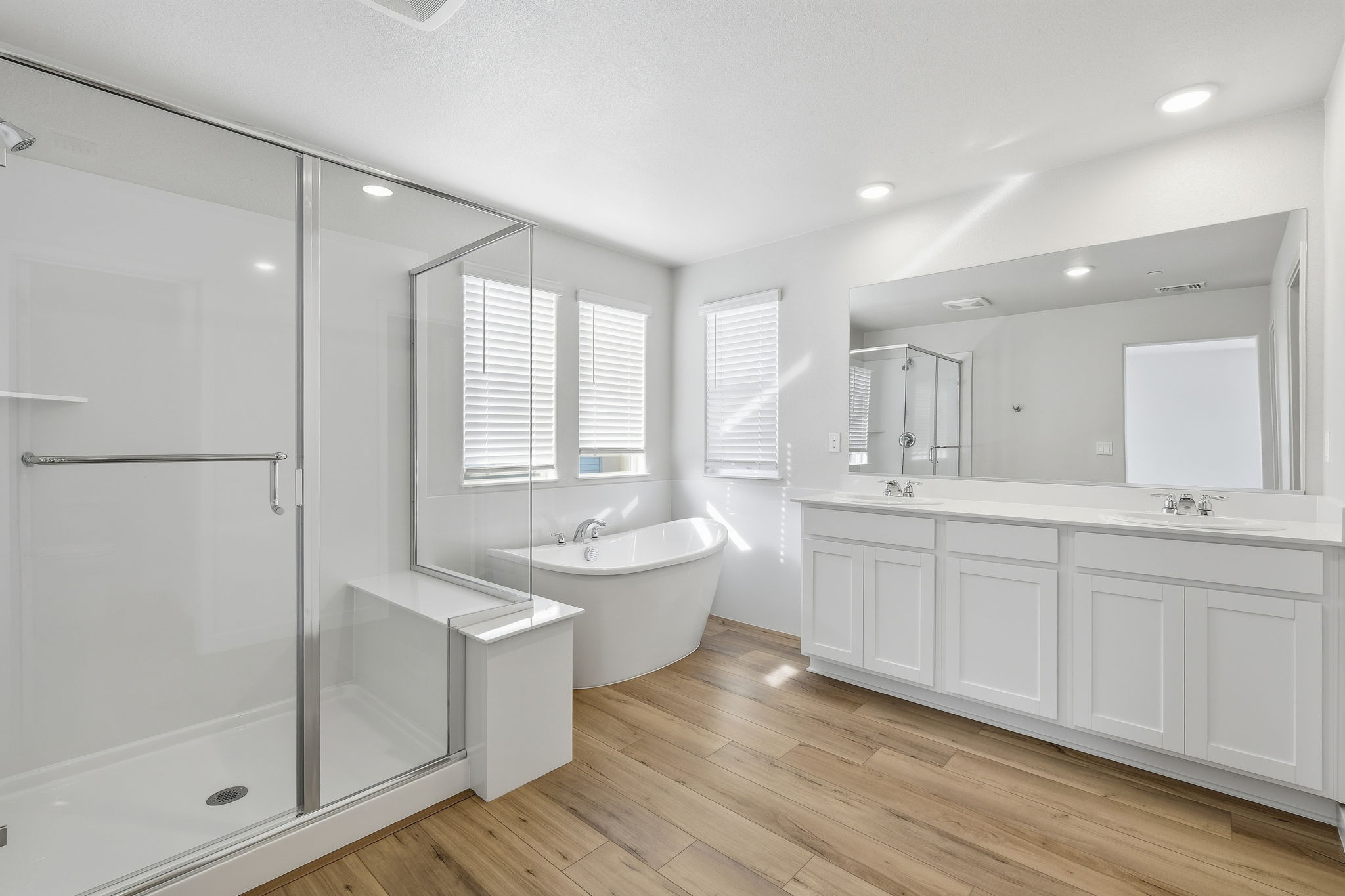 A bathroom with a tub sink and a shower.