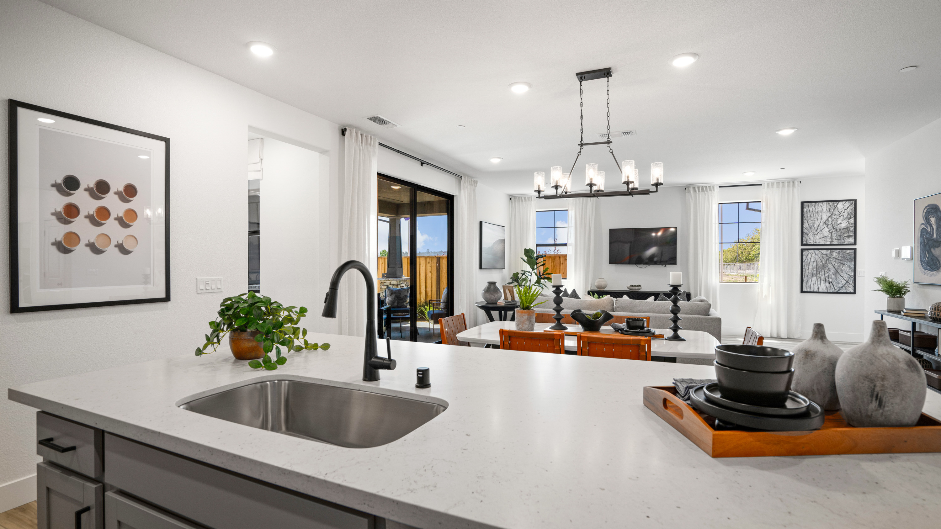 A kitchen with a sink and a large window.