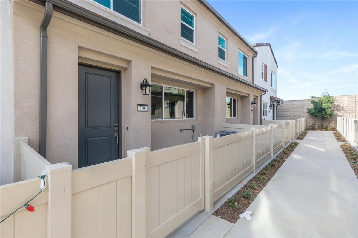 A white building with a white fence.