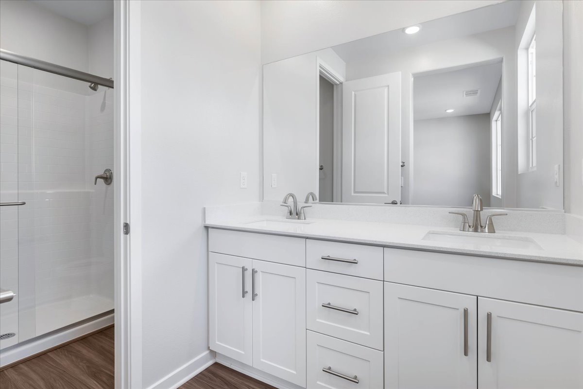A bathroom with white cabinets.