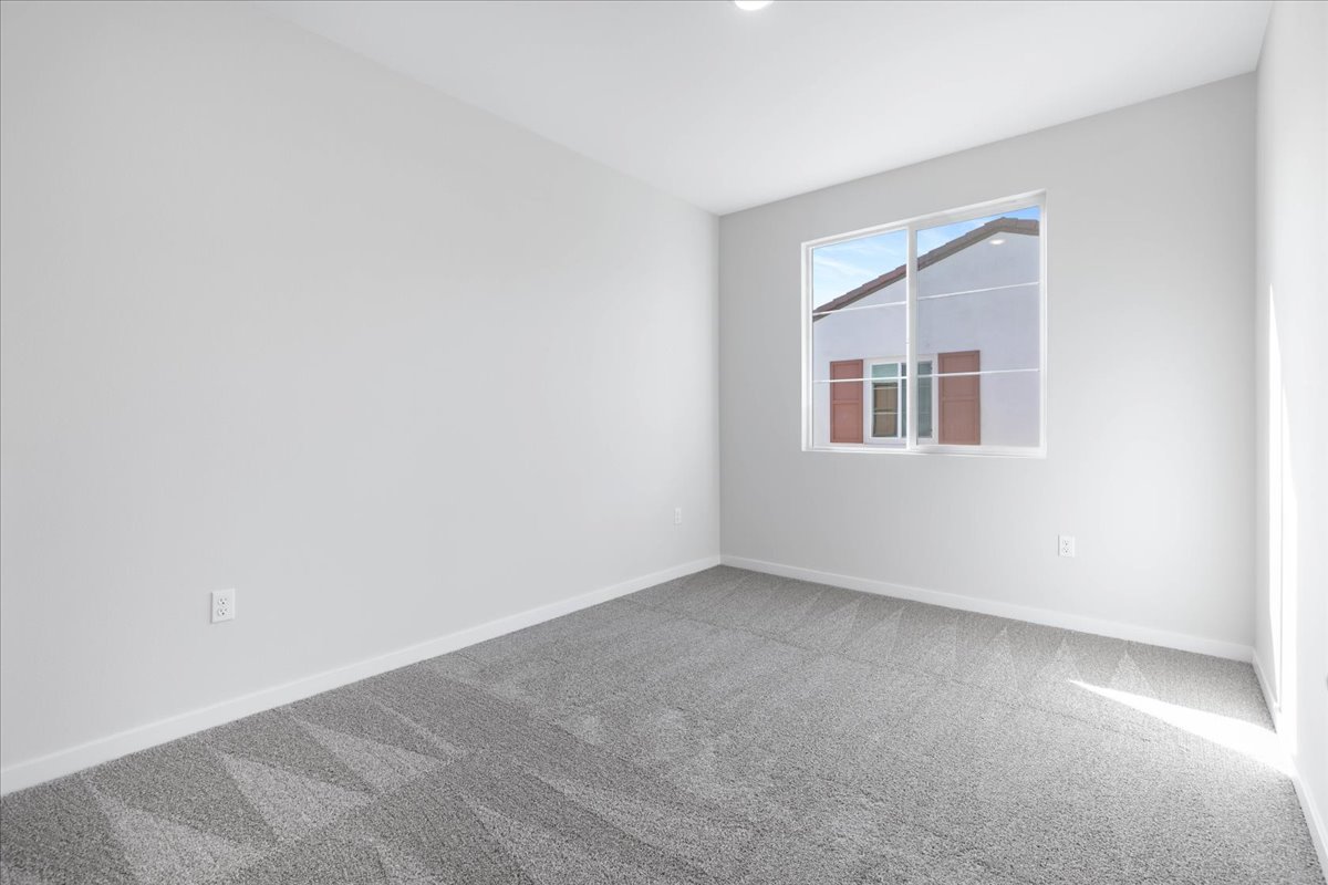 A room with a window and a carpet.