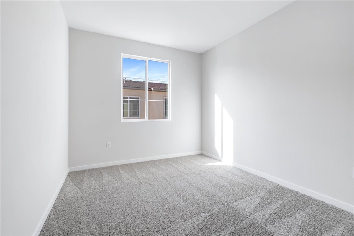 A room with a window and carpet.