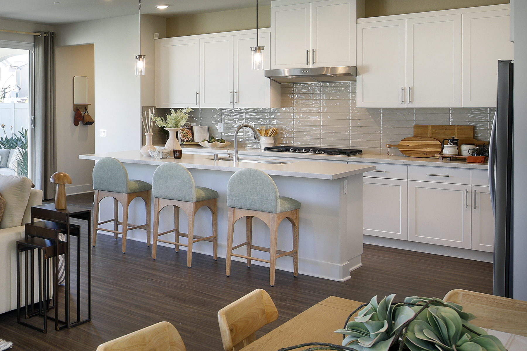 A kitchen with white cabinets.