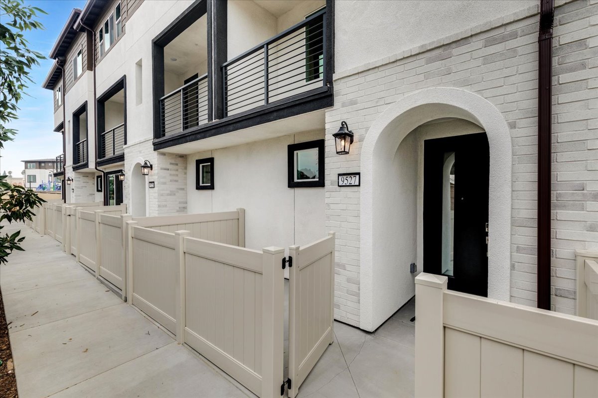 A white building with a walkway.