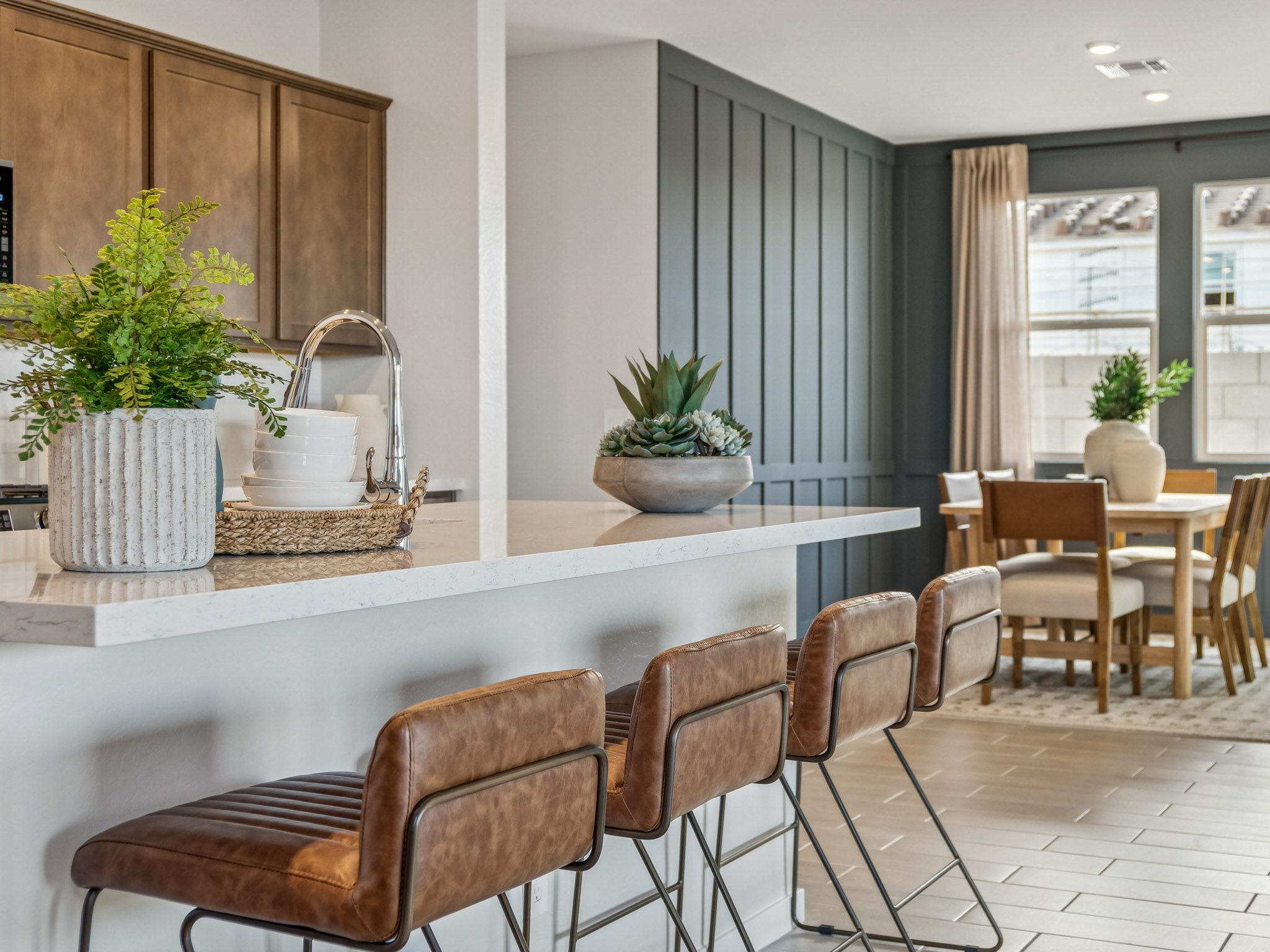 A kitchen with a table and chairs.