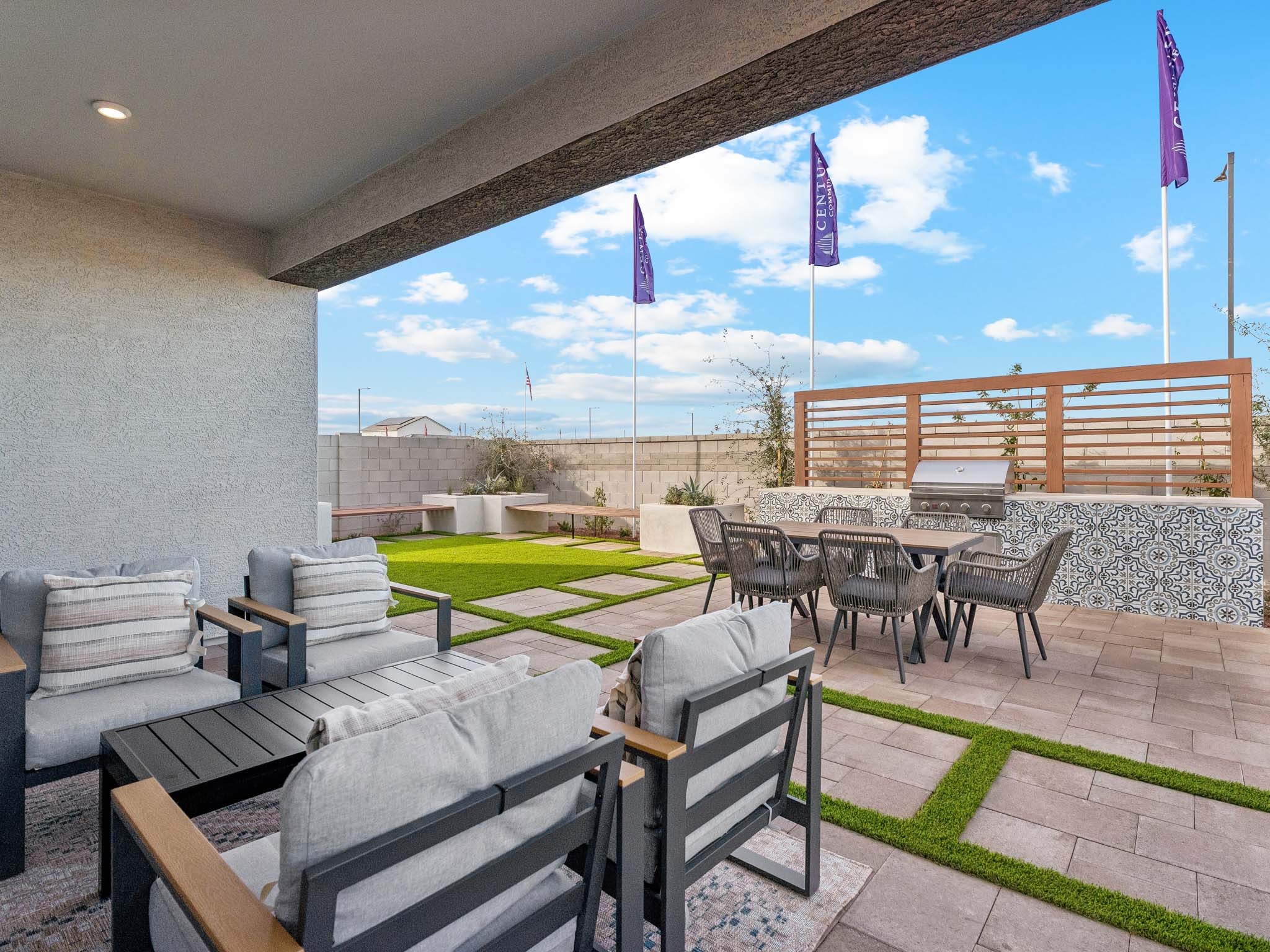 A patio with tables and chairs.