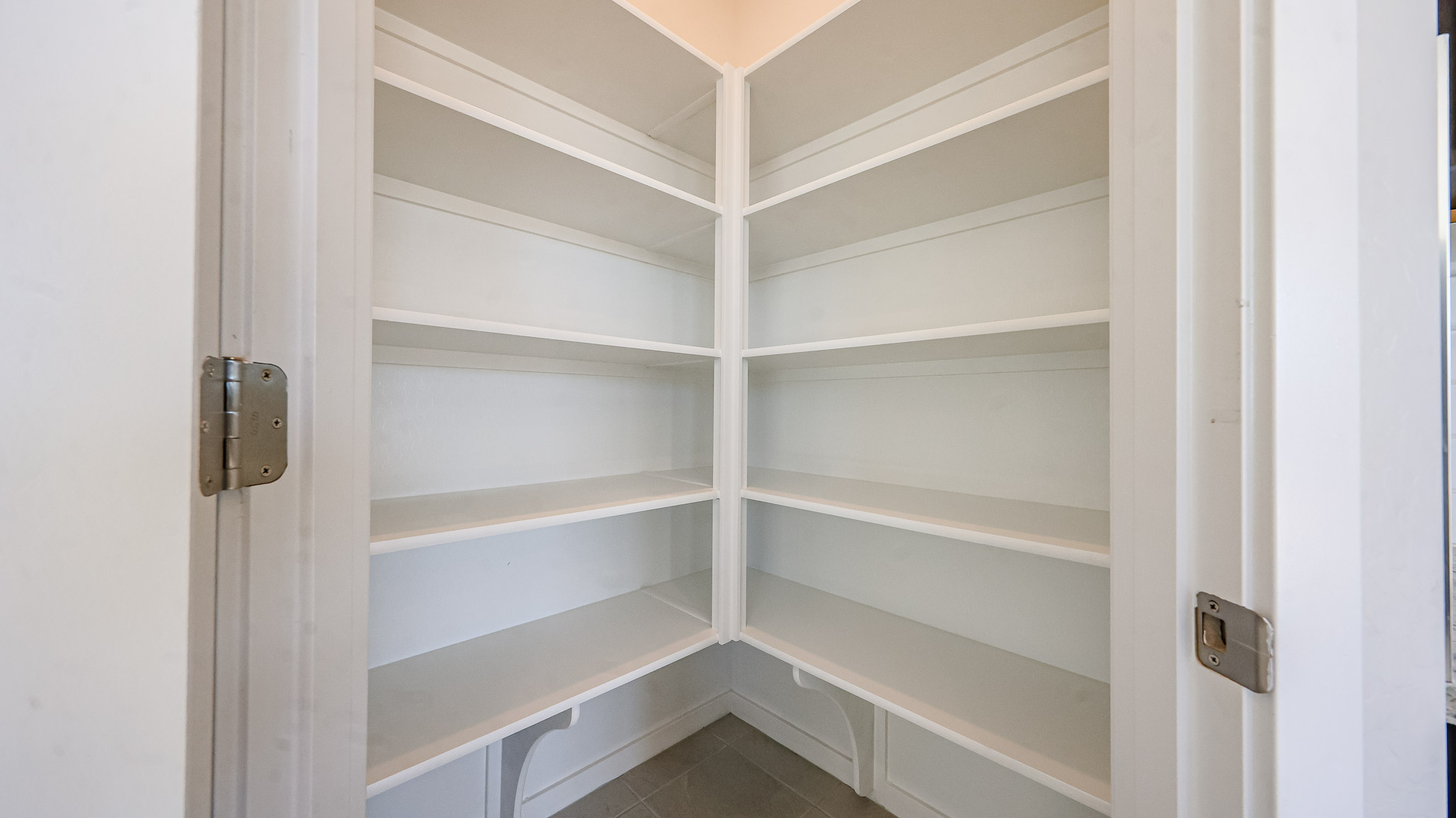 A white shelf with a door.