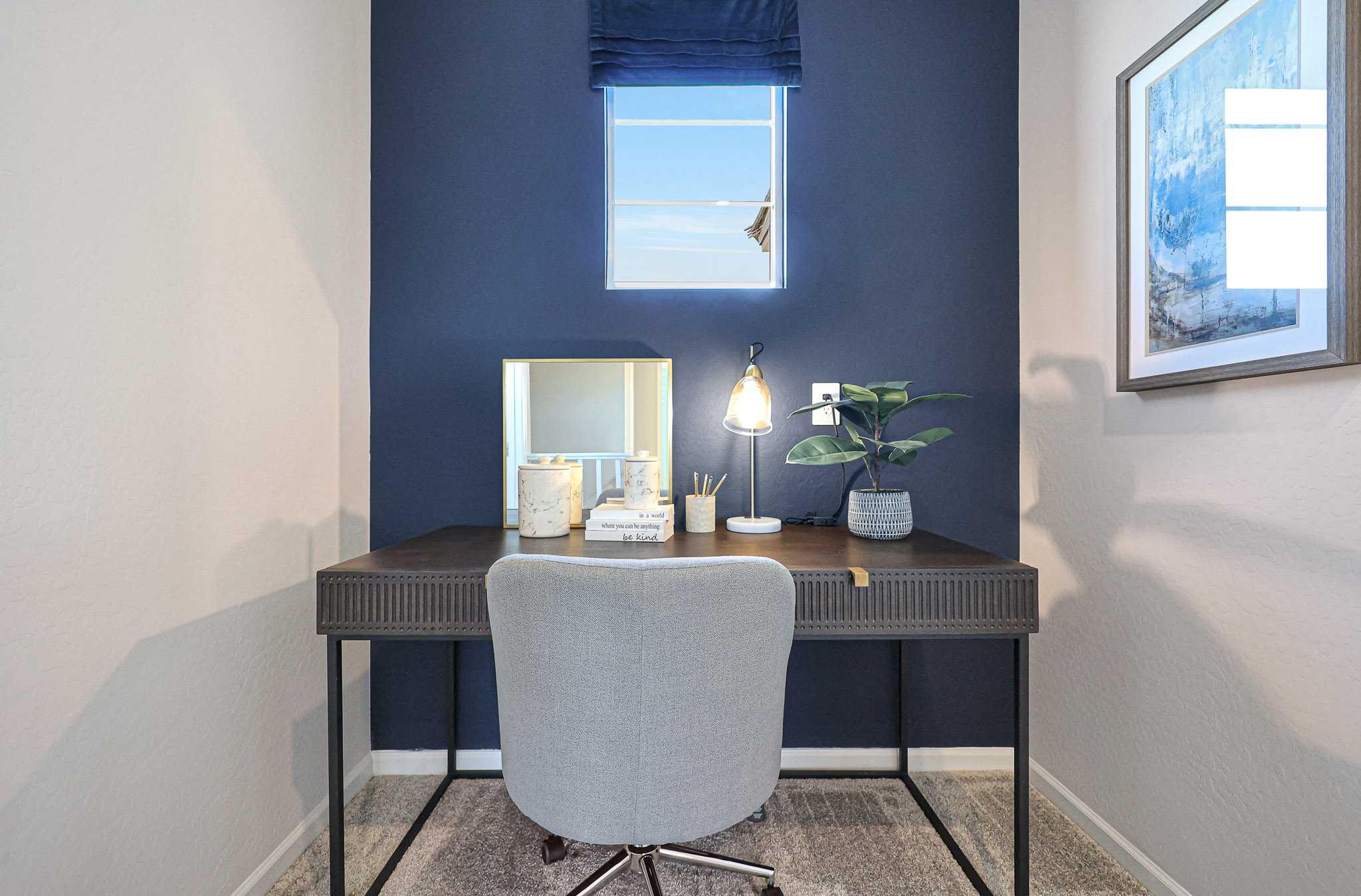 A desk with a chair and a window.