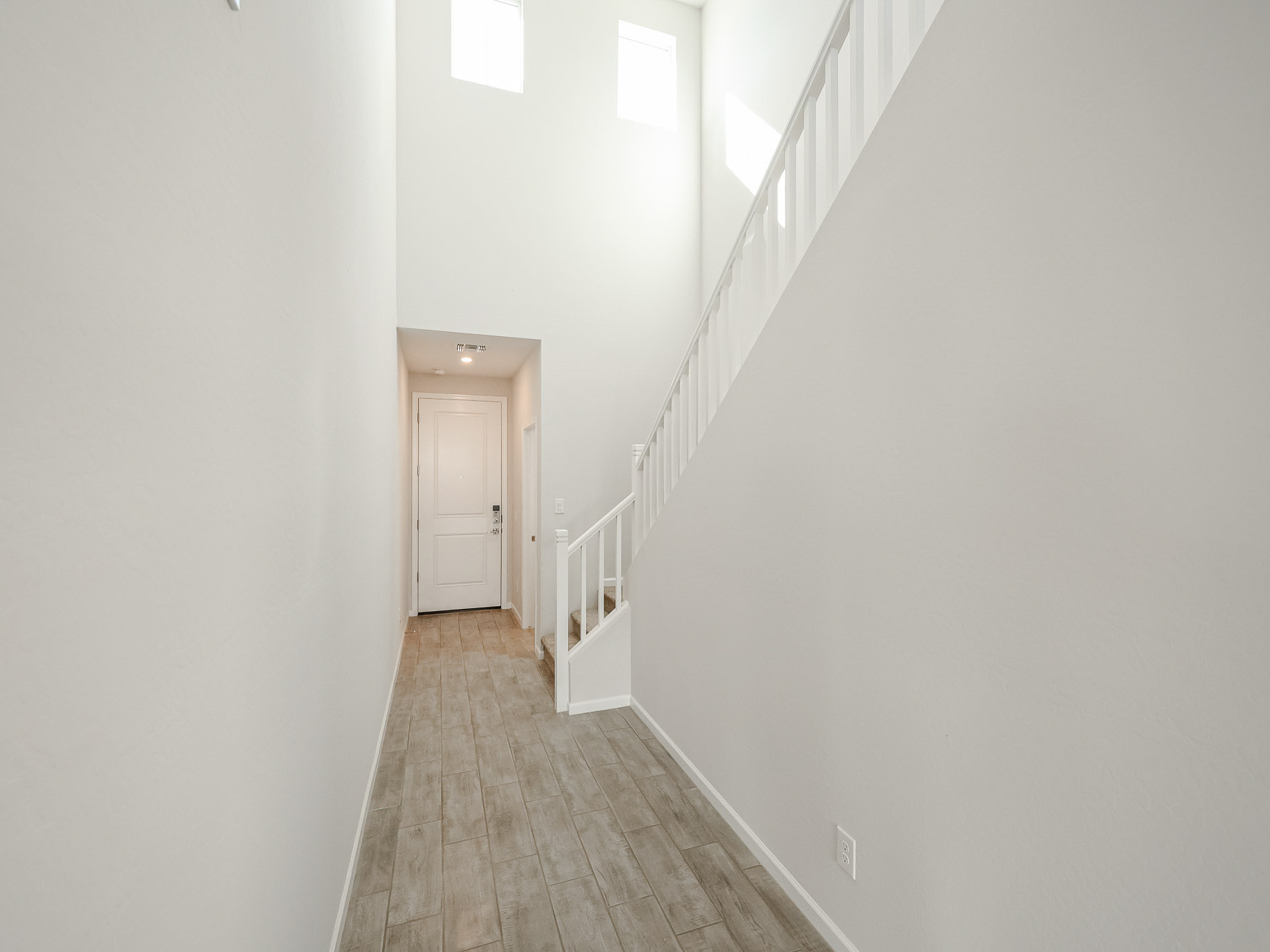 A hallway with white walls.