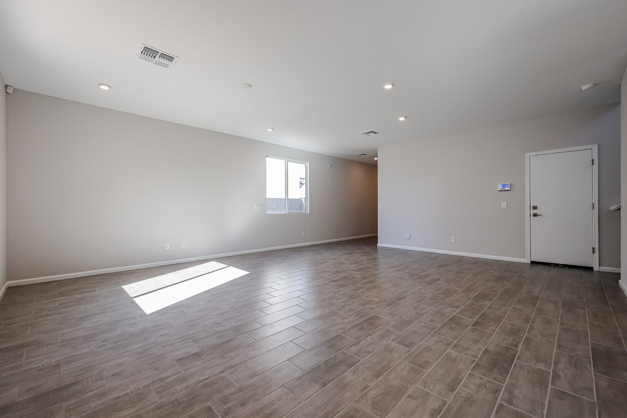 A room with a wood floor and a white door.