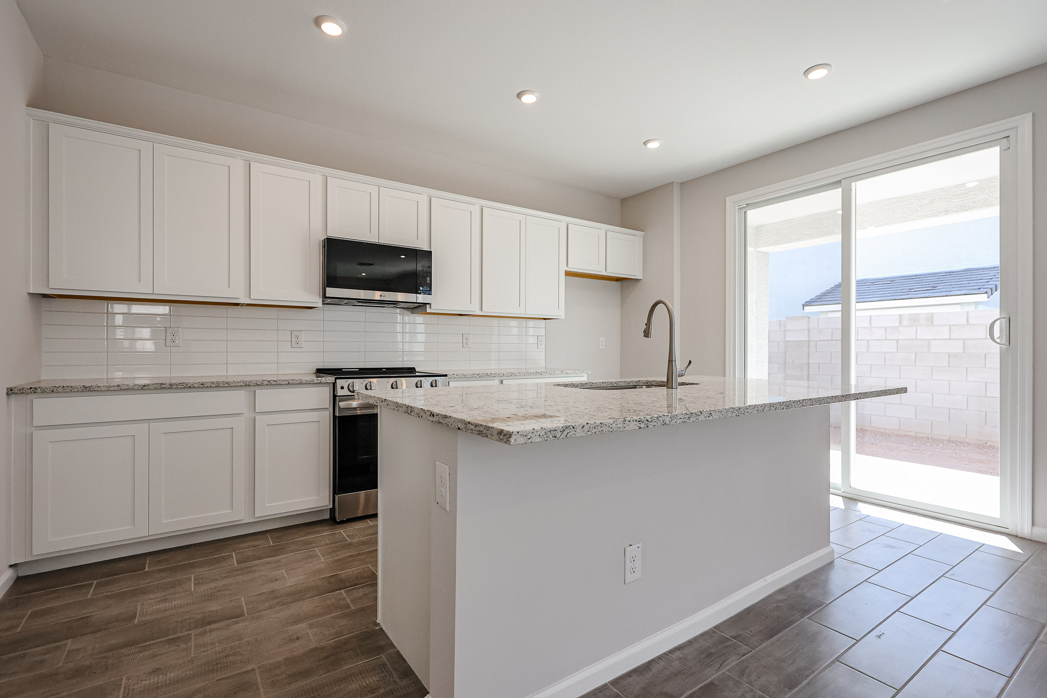 A kitchen with white cabinets.