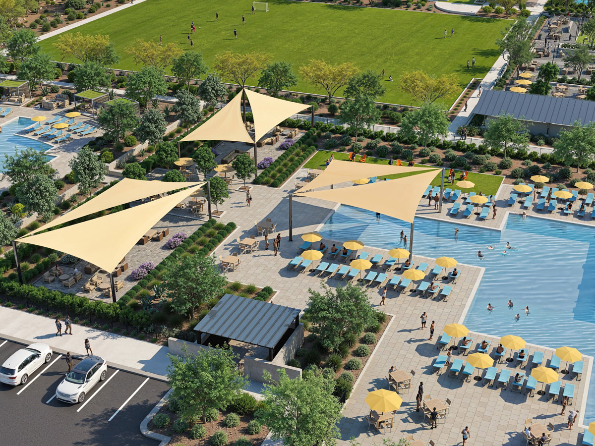 A pool with yellow umbrellas and people in it.