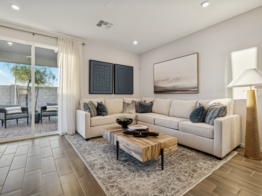 A living room with a white couch and a coffee table.