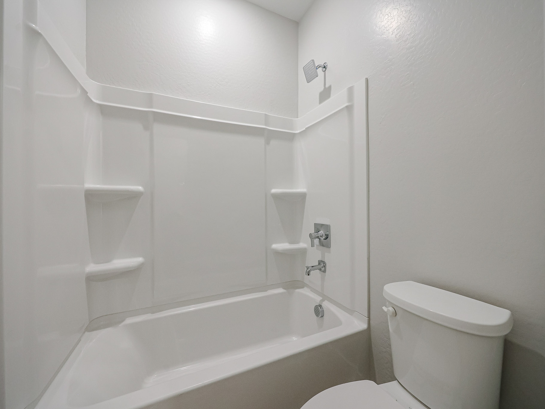 A bathroom with a tub toilet and sink.