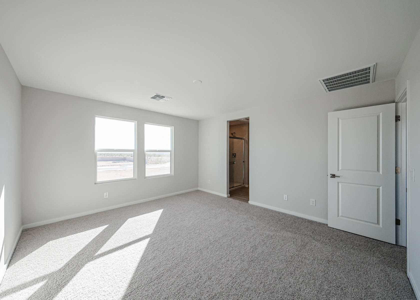 A room with white walls and a door.