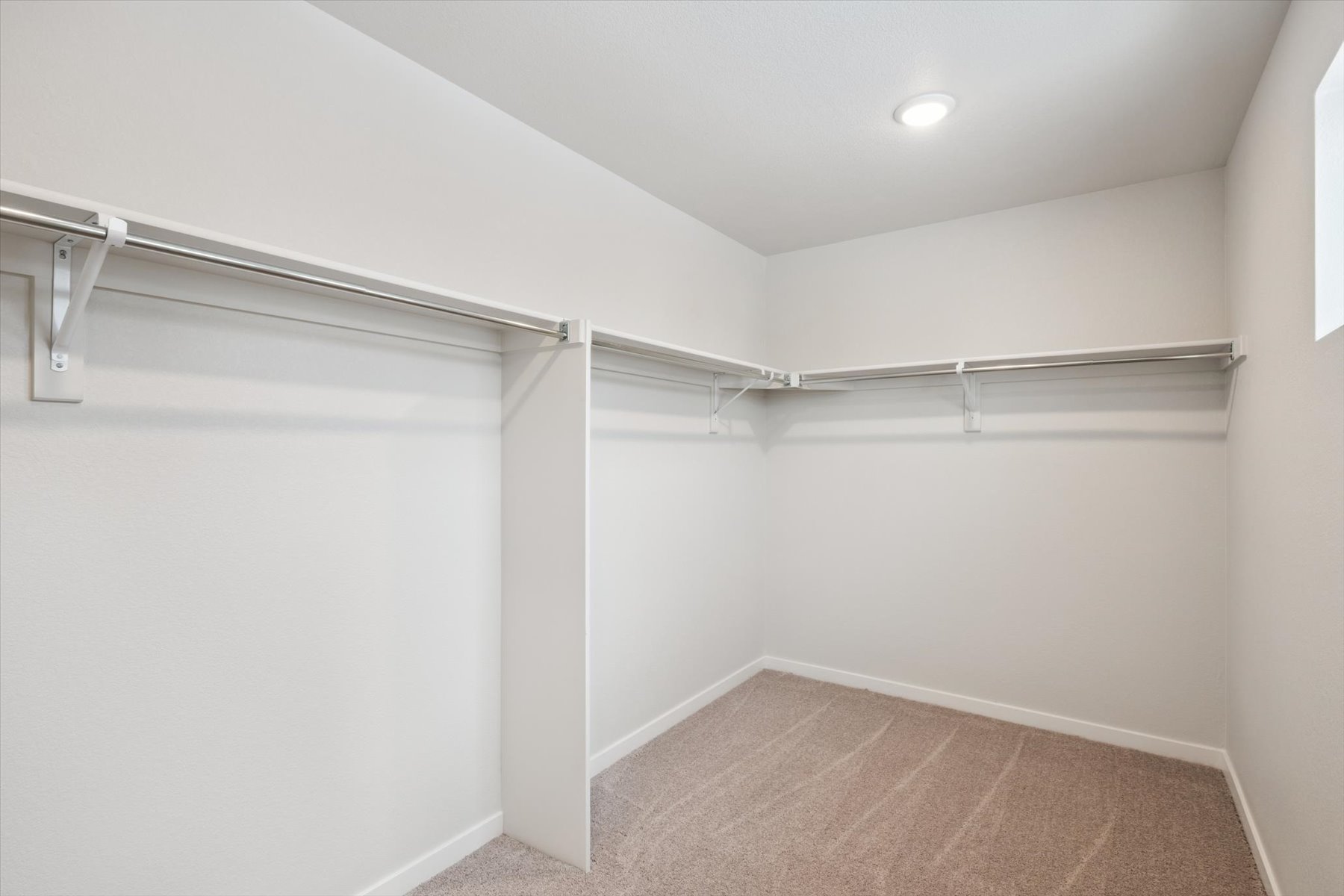 A white room with a metal railing.