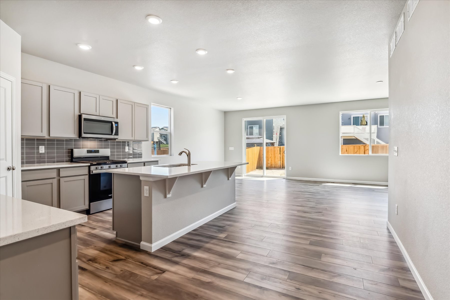 A kitchen with white cabinets.