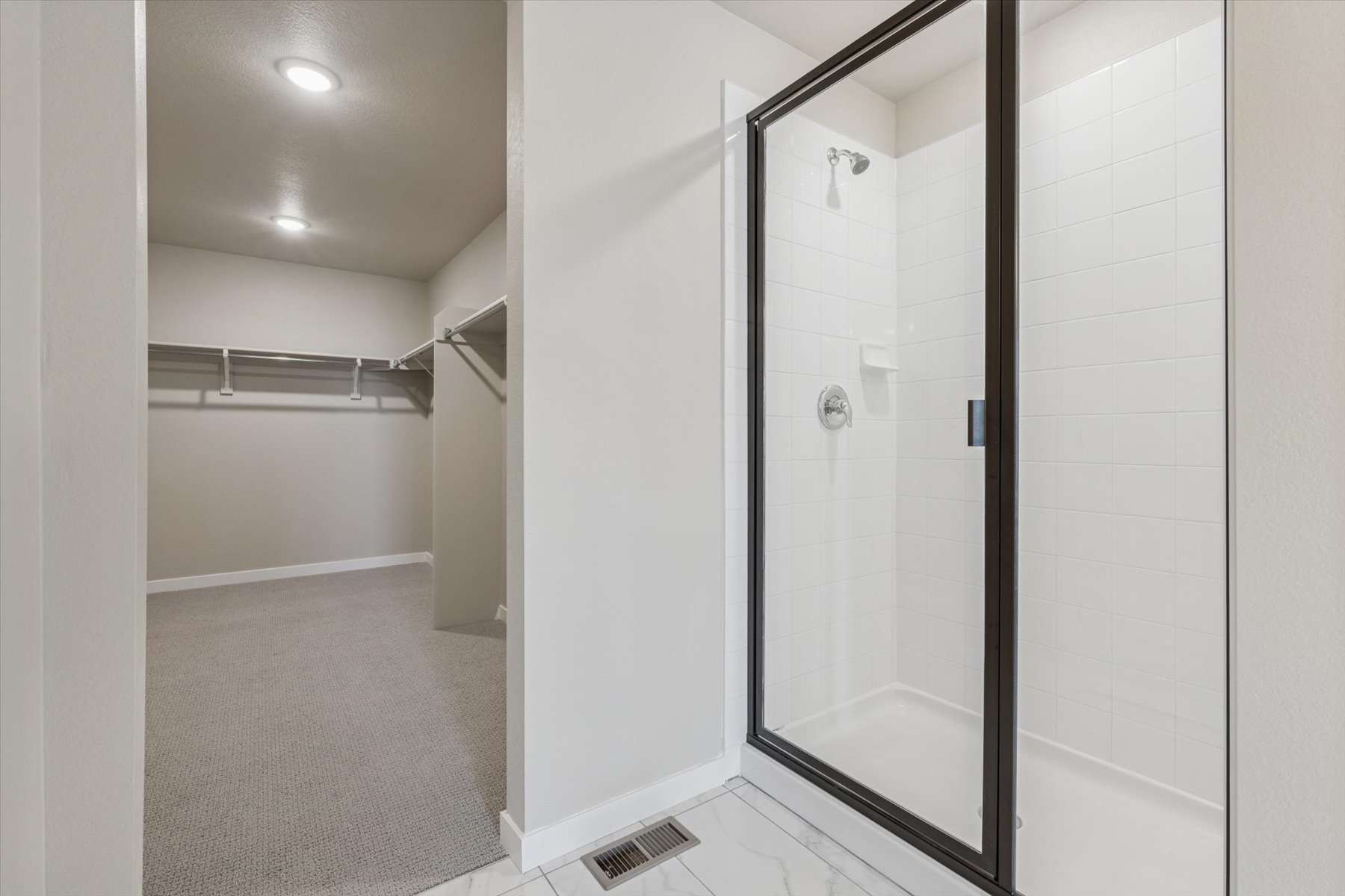 A shower with a glass door.