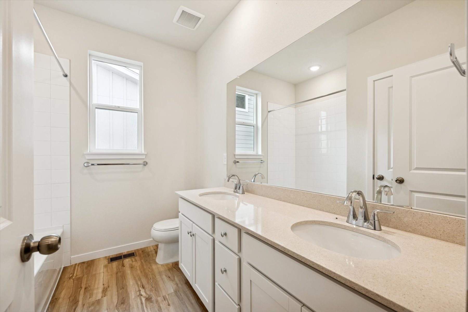 A bathroom with a large mirror.