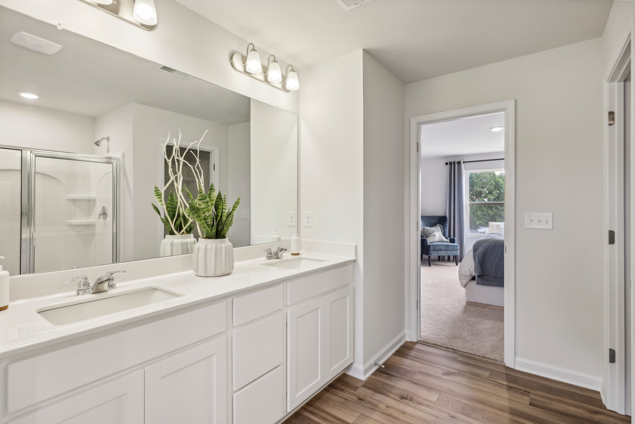 A bathroom with a large mirror.