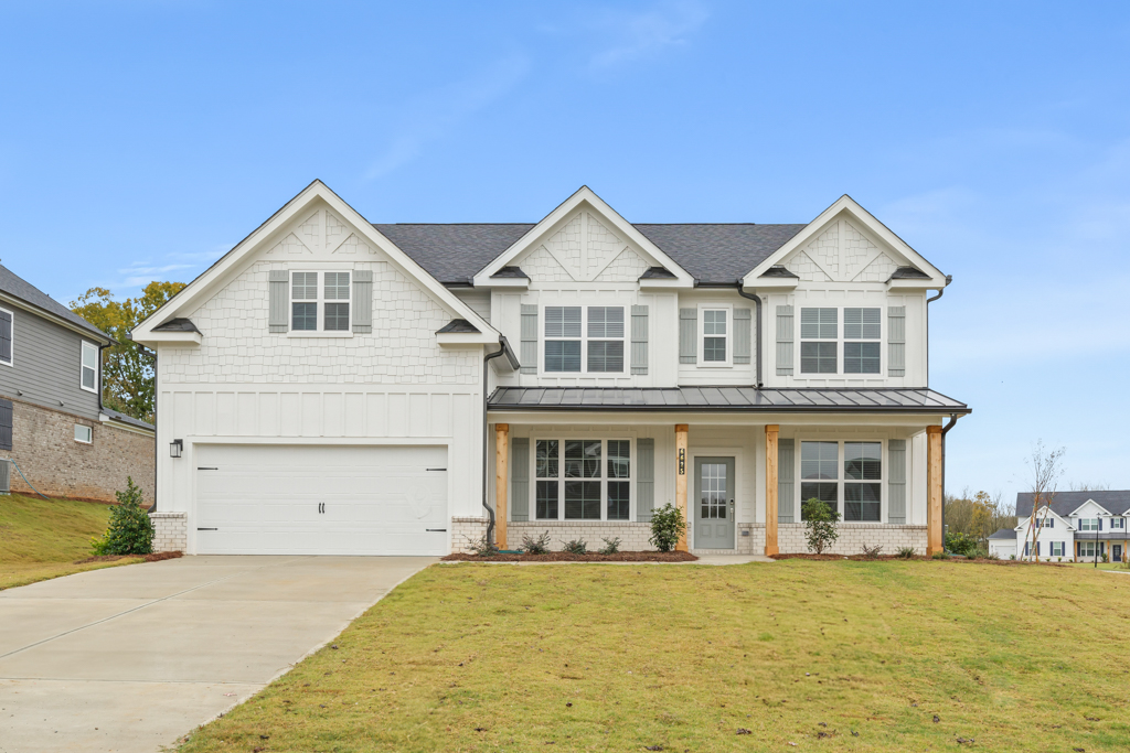 A white house with a garage.