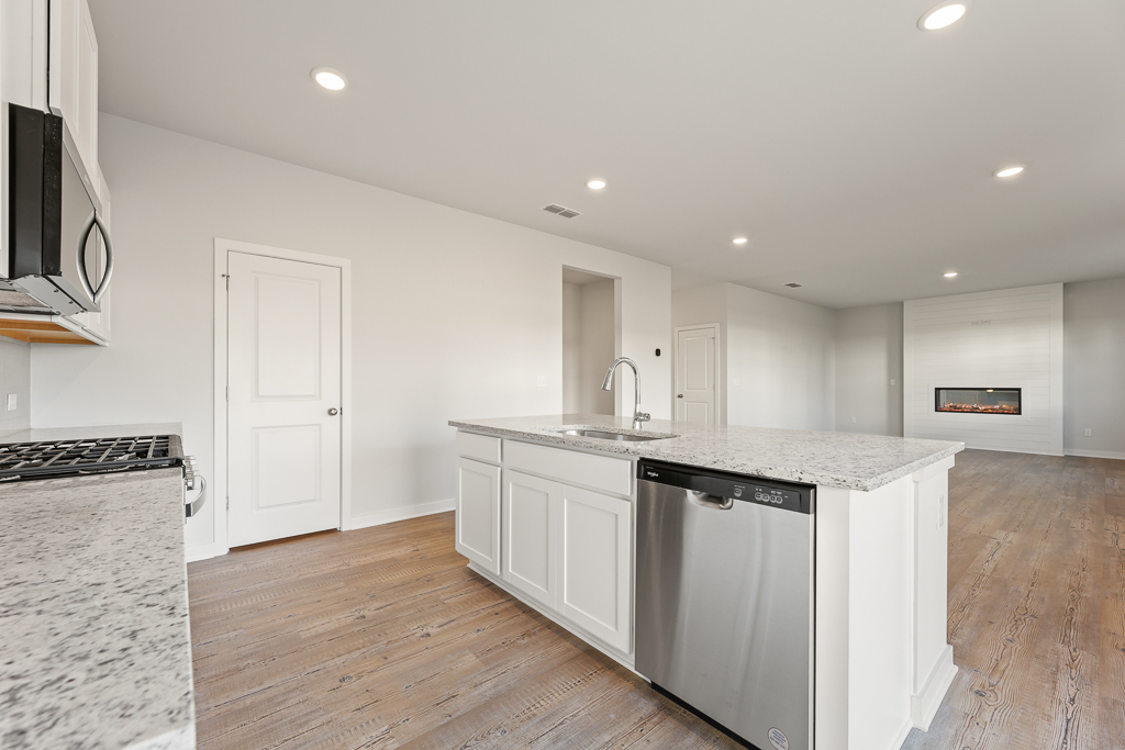 A kitchen with white cabinets.