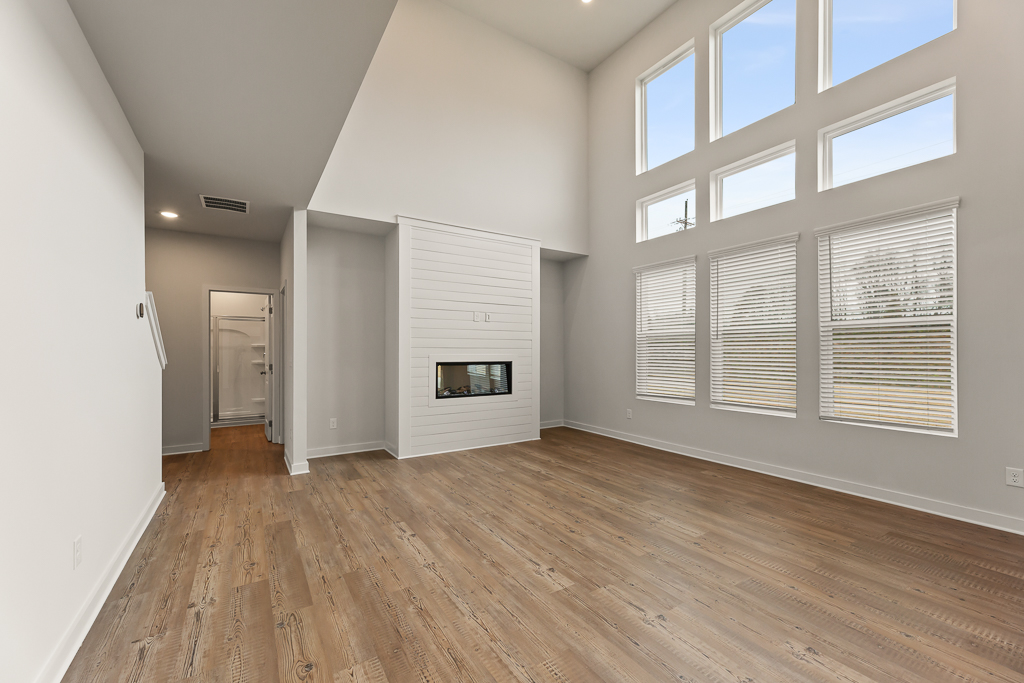 A room with a fireplace and a wood floor.