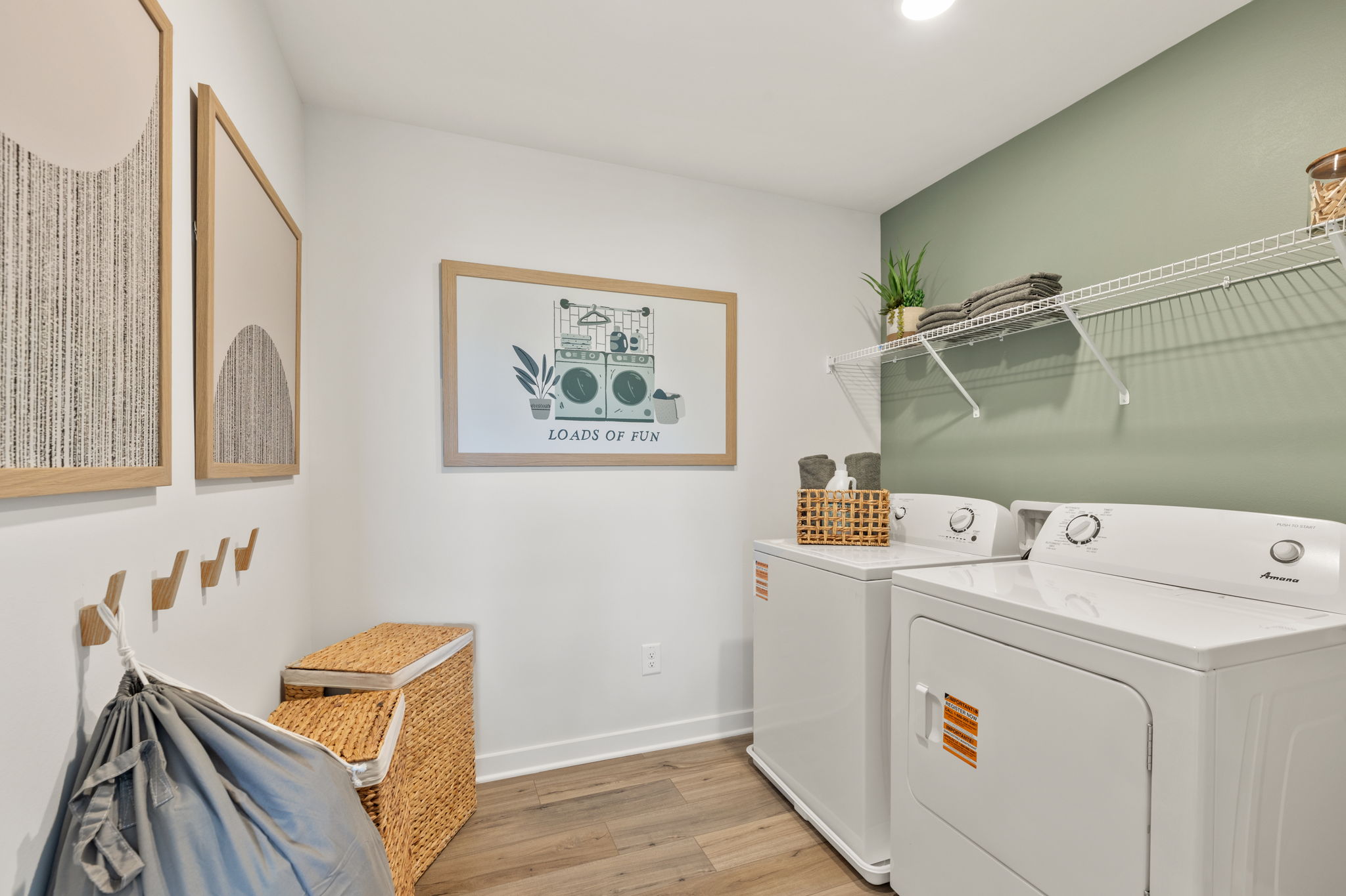 A white laundry room with a washer and dryer.