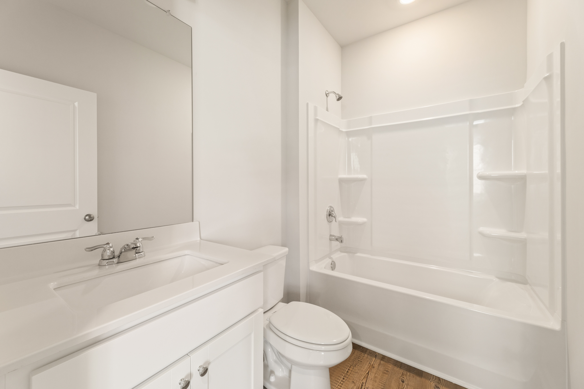 A bathroom with a tub sink and toilet.