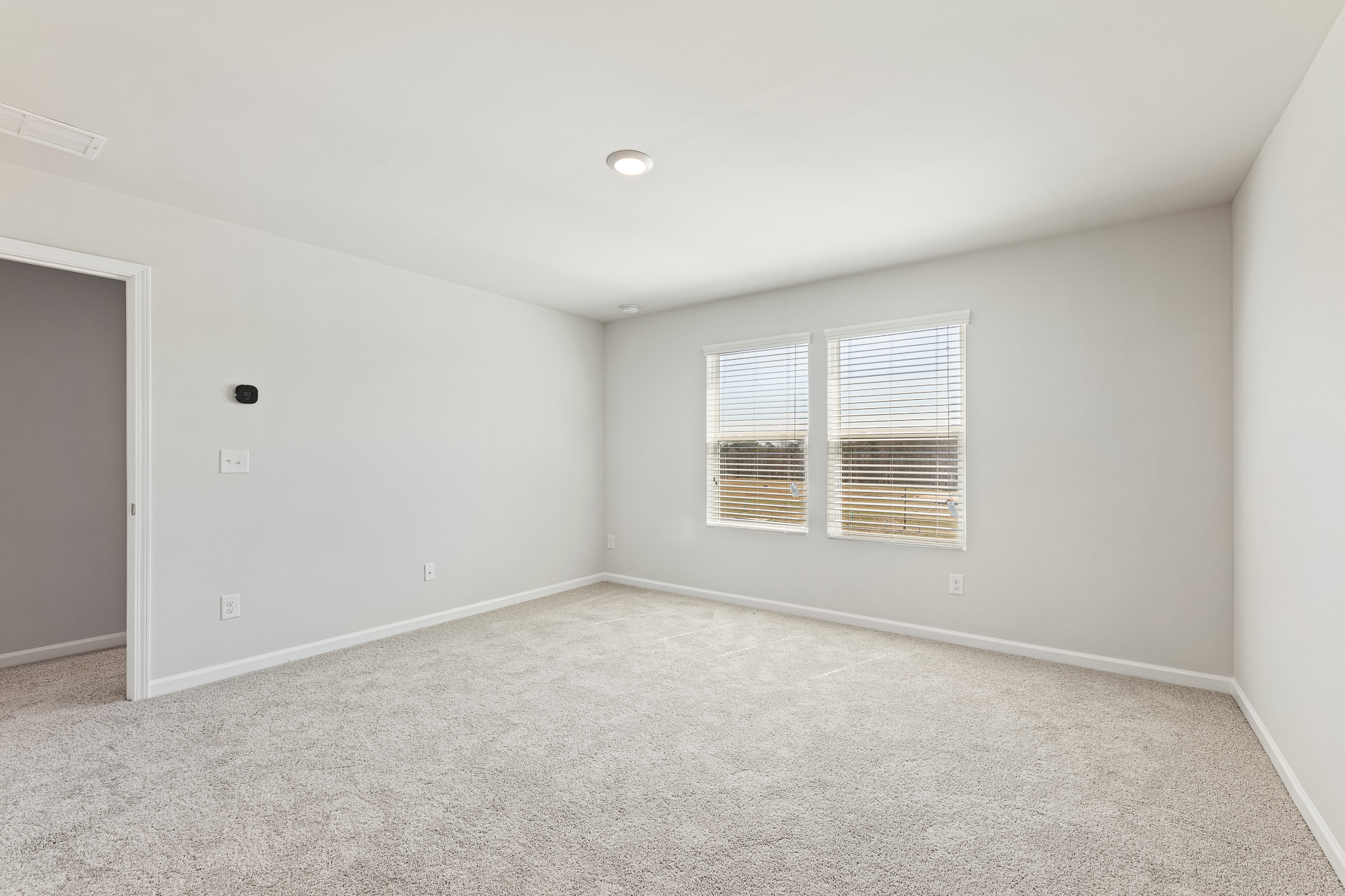 A room with a window and a door.