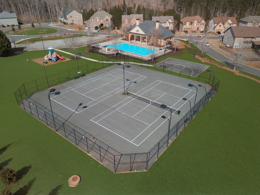 A tennis court with a small pool.