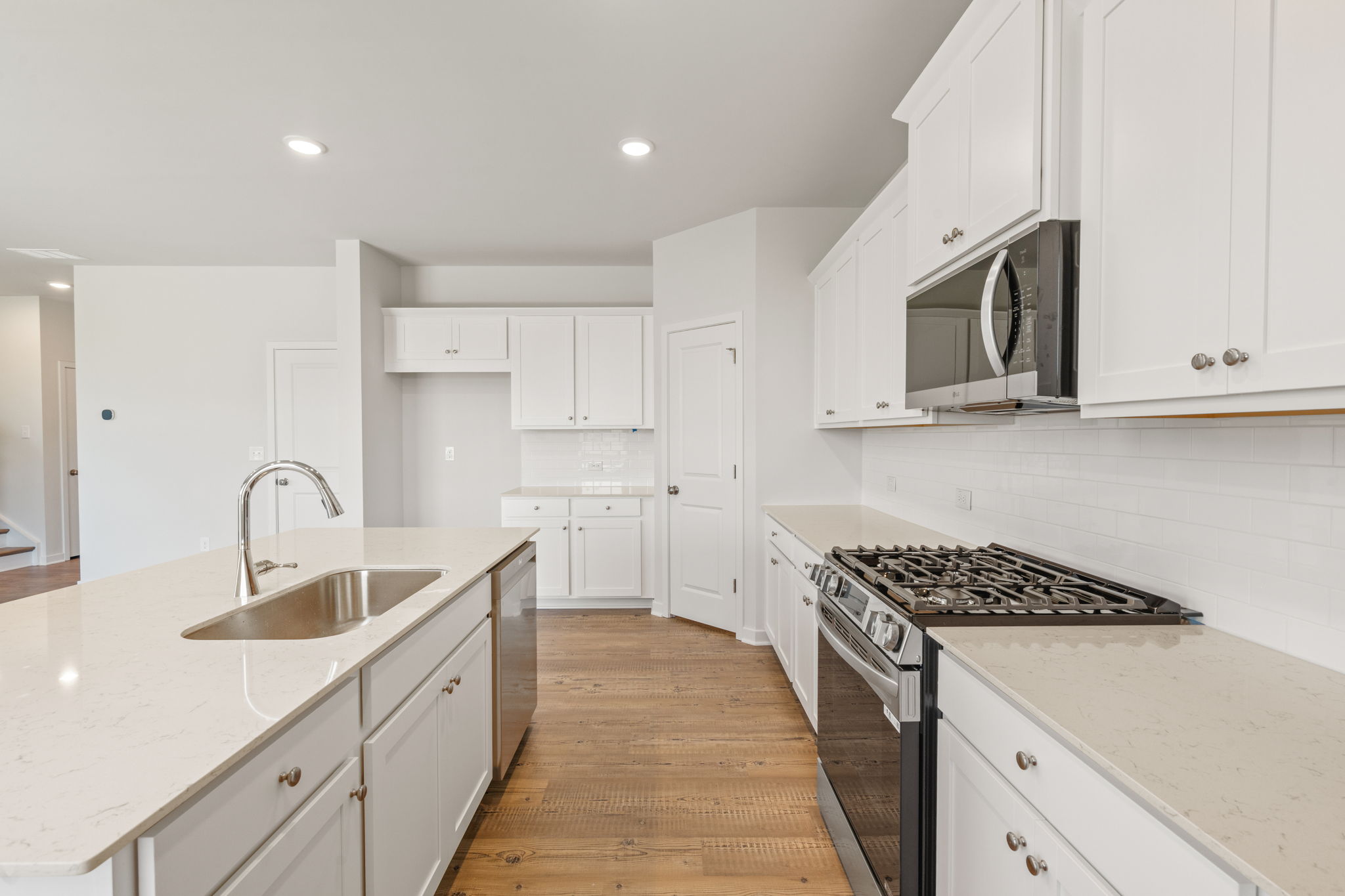 A kitchen with white cabinets.