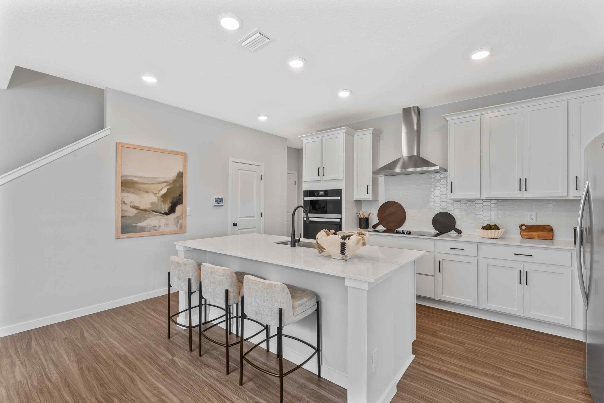 Silverbell II Model Home Chef's Kitchen with White Cabinets at Camden Woods in Kingsland, GA