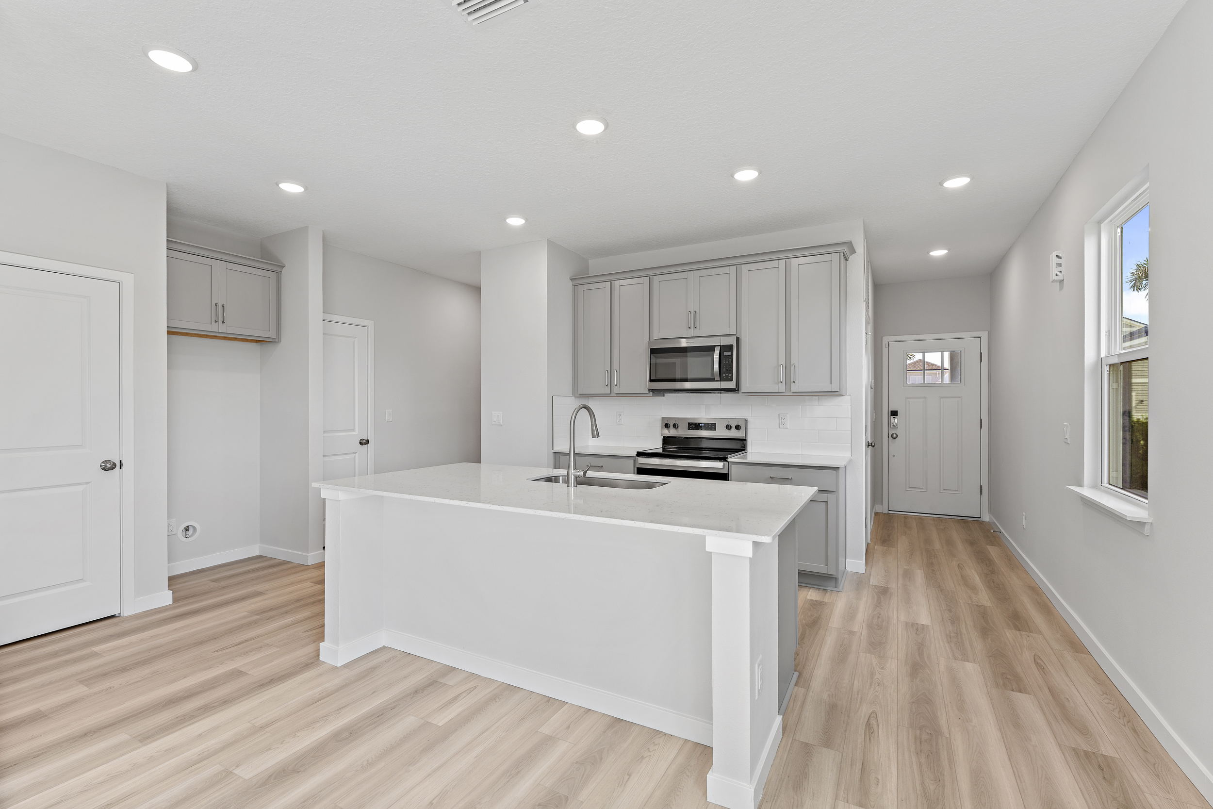 Kitchen with Gray Cabinets in Lot 19 Cedar II at Camden Woods in Kingsland, GA