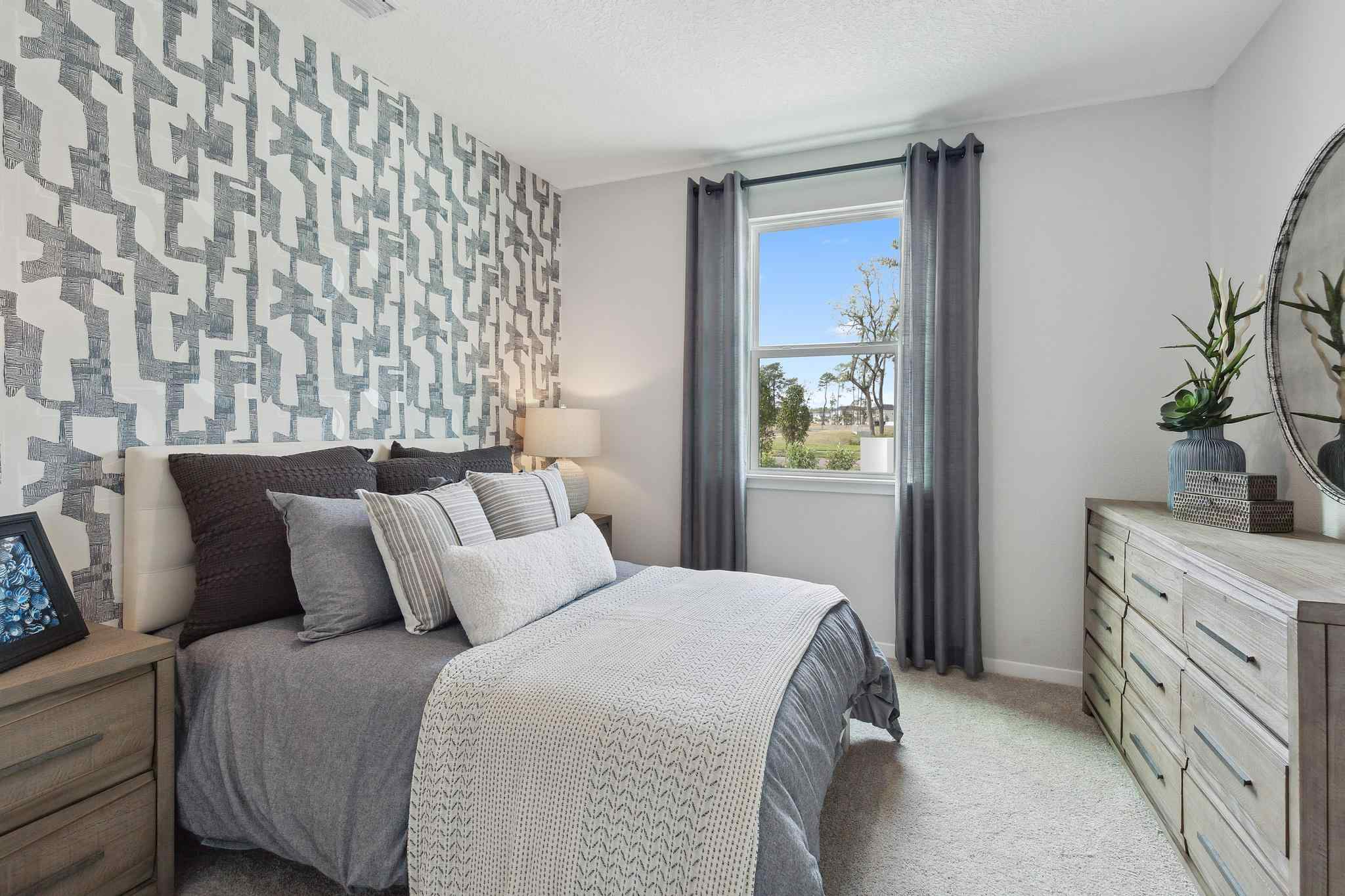 A bedroom with a bed and a window.