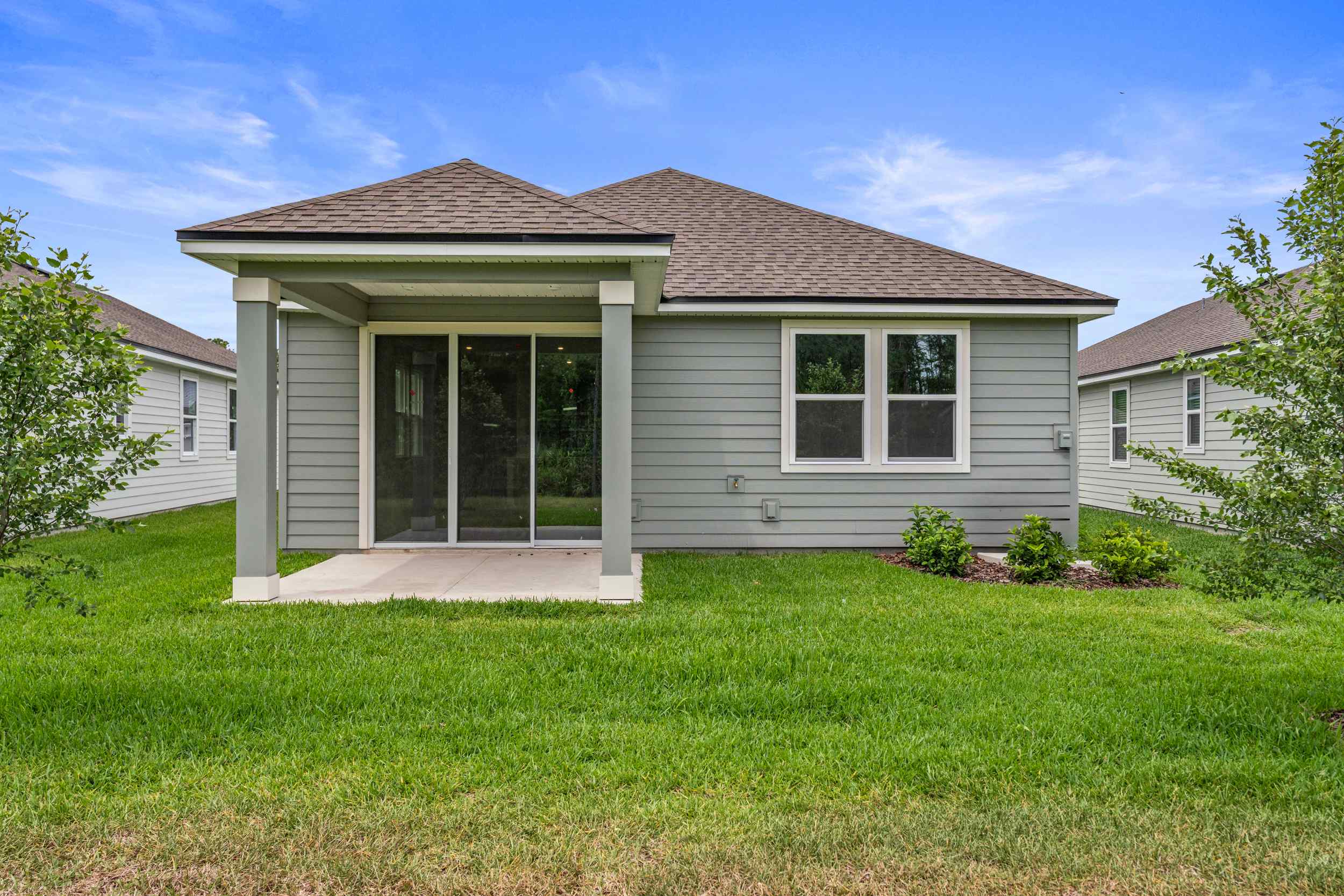 Sanibel II Floorplan Lot 147 Backyard with Covered Patio at Seminole Palms in Palm Coast