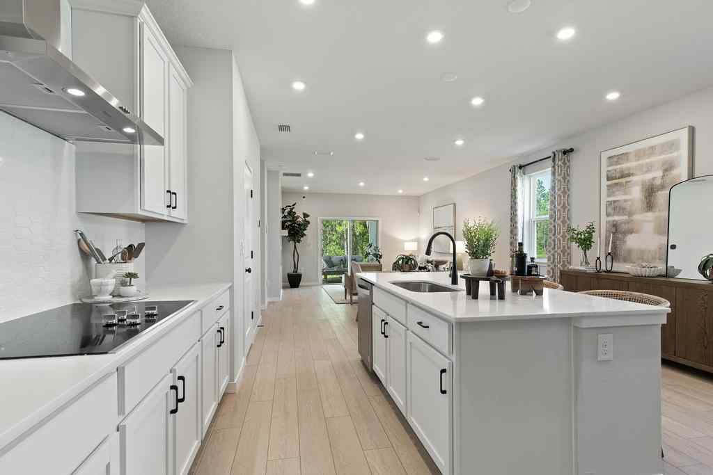 A kitchen with white cabinets.