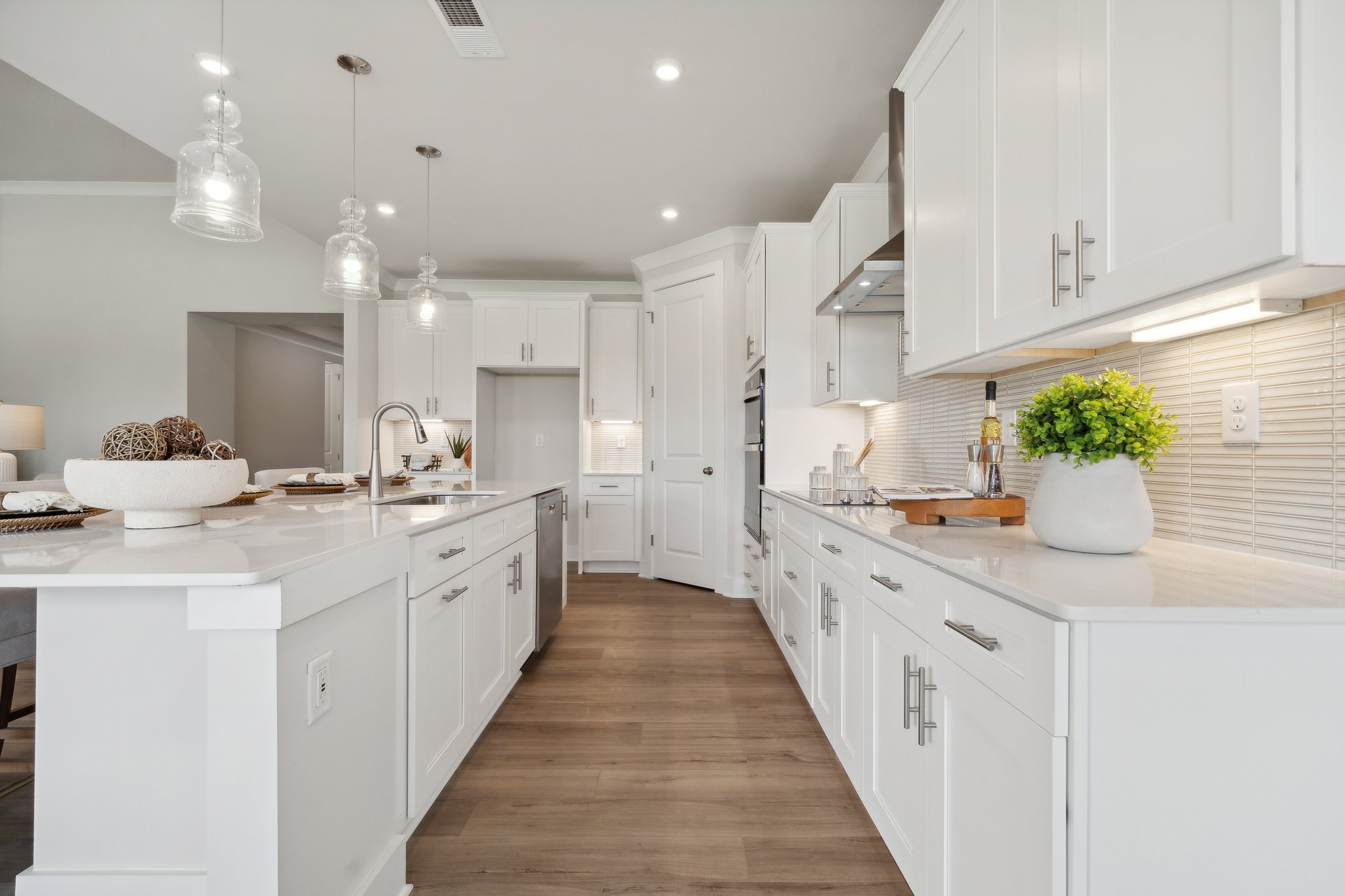 A kitchen with white cabinets.