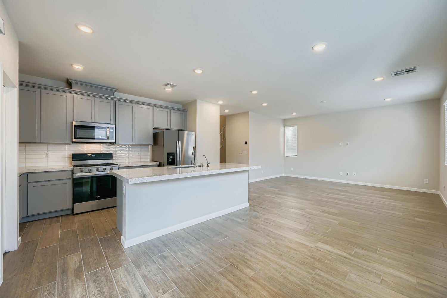A kitchen with white cabinets.
