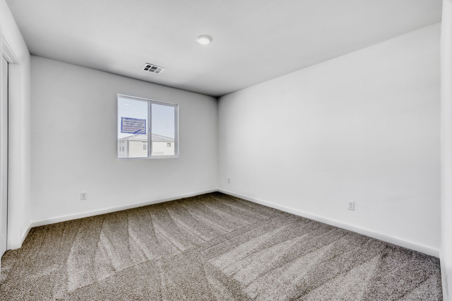A room with a carpet and a rug.