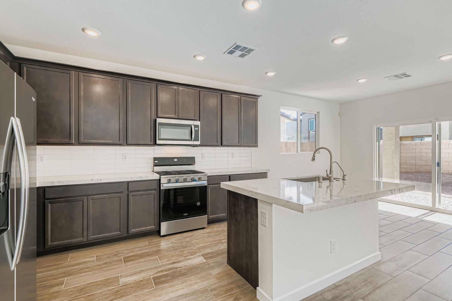 A kitchen with black cabinets.