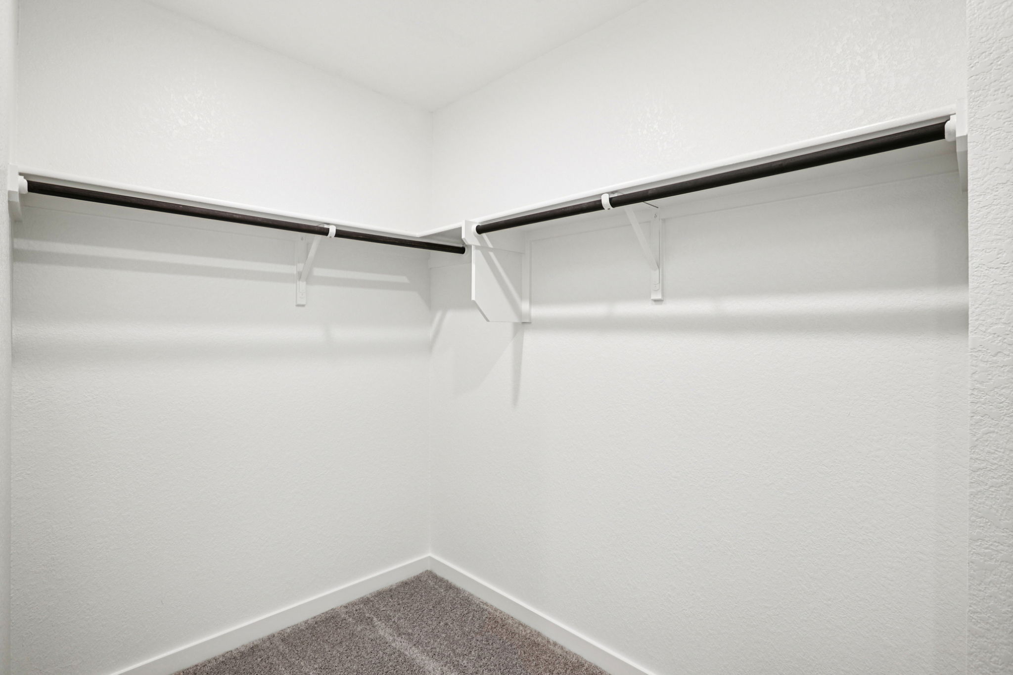 A white wall with a metal railing.