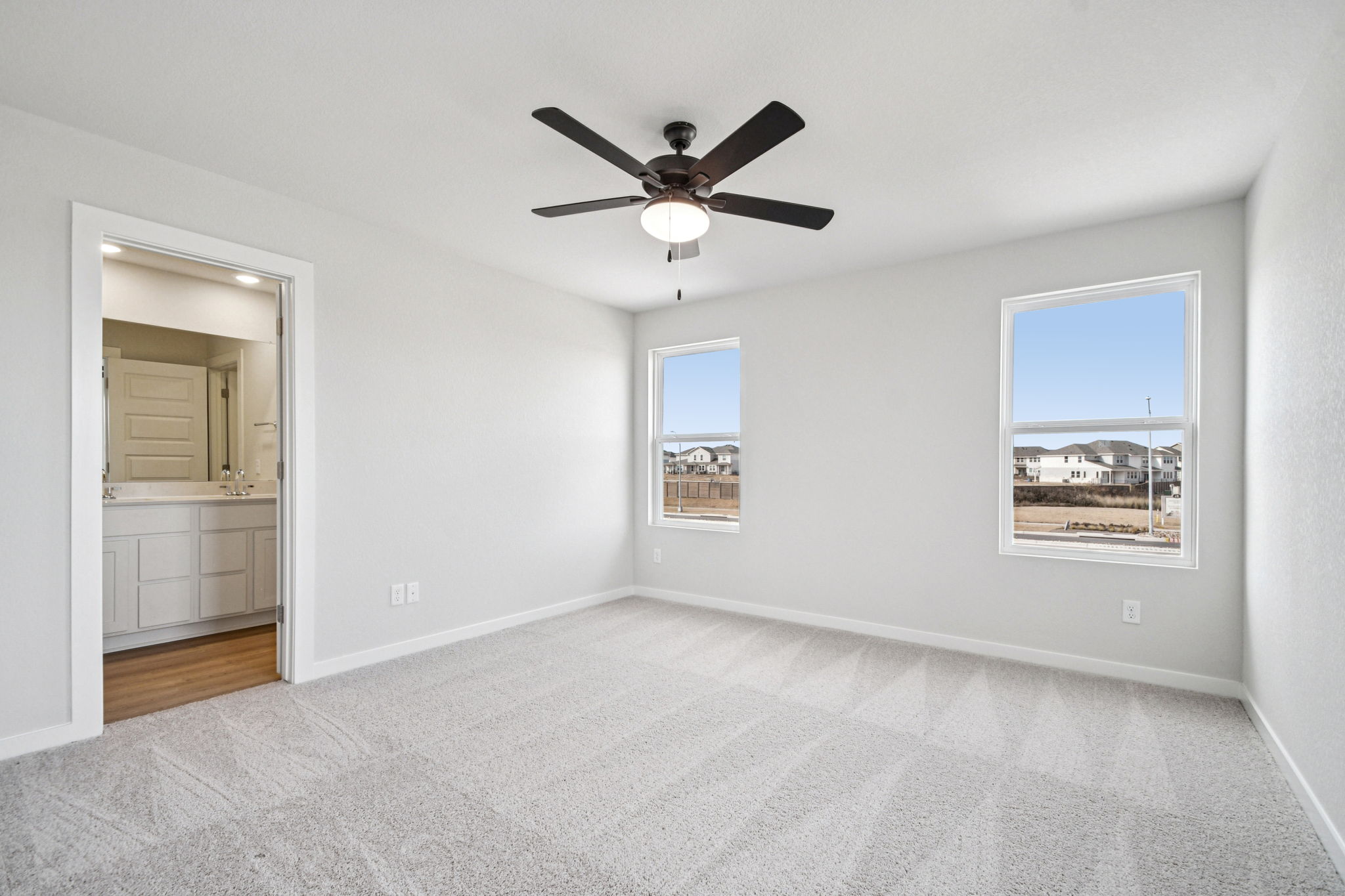 A room with a ceiling fan and a window.