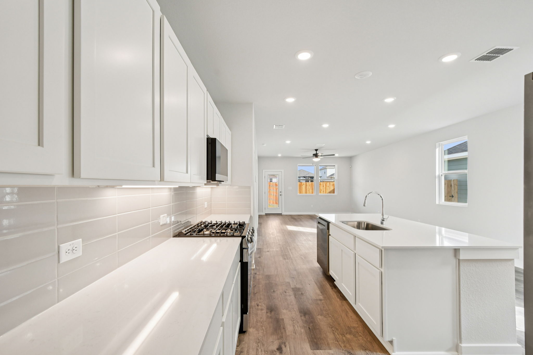 A kitchen with white cabinets.
