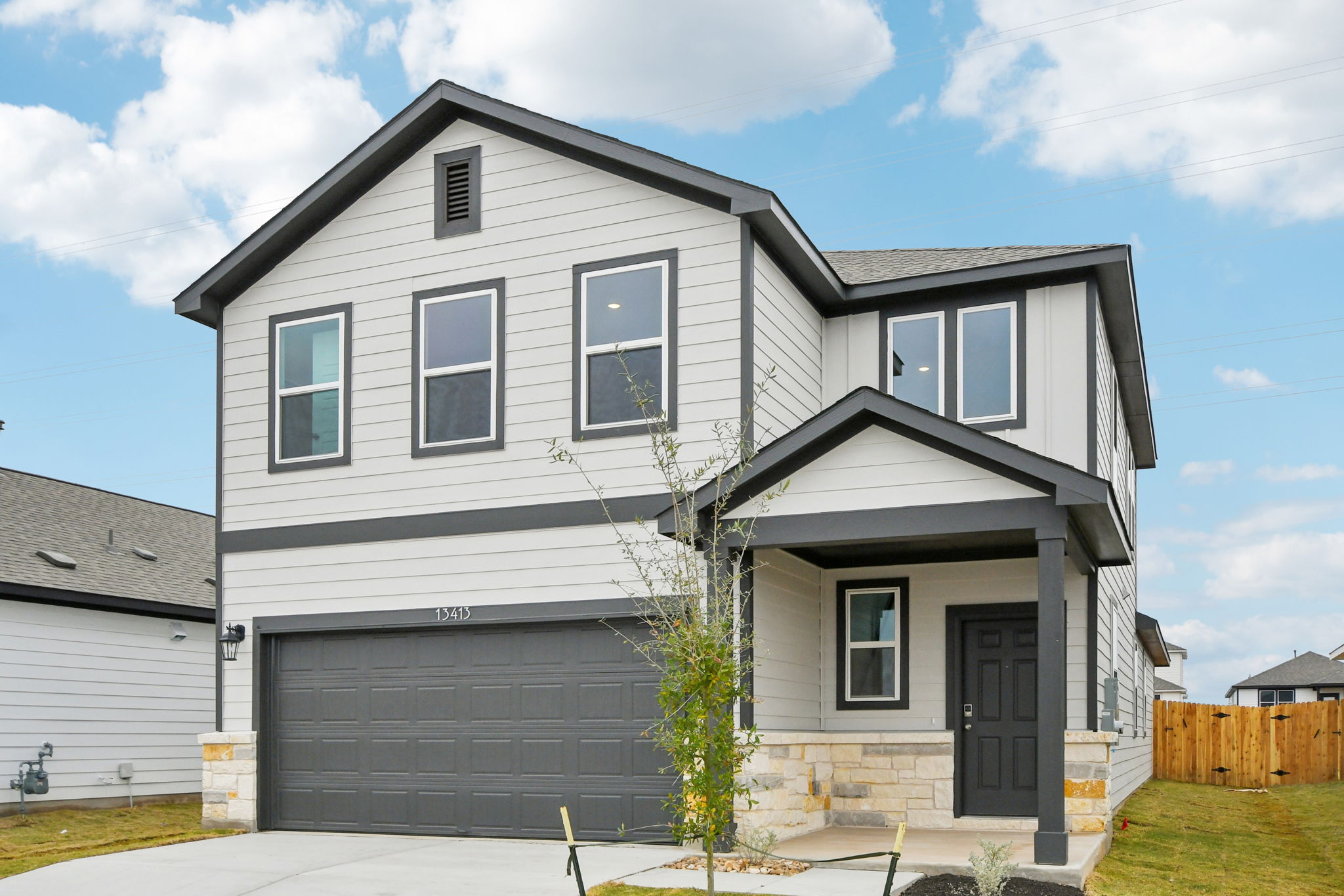 A grey house with a garage.