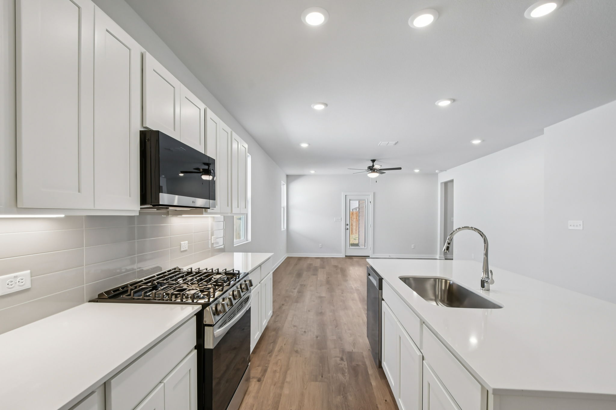 A kitchen with white cabinets.
