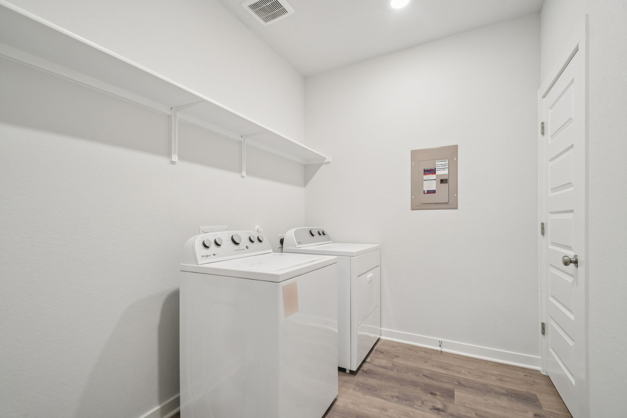 A white kitchen with a white counter top and white cabinets.