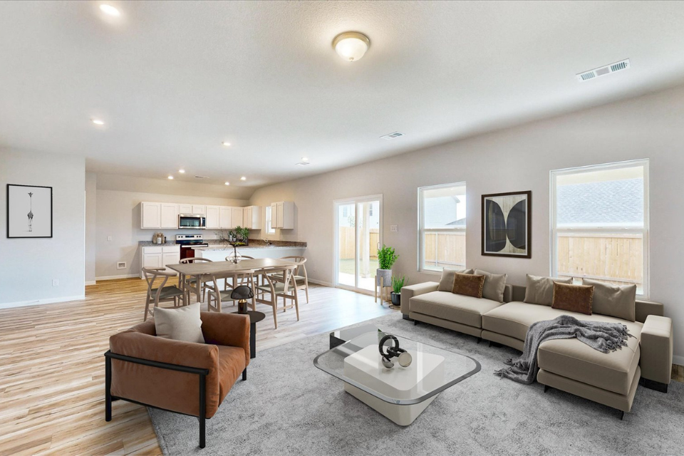 A living room with a large table and chairs.